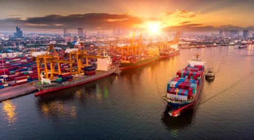 Cargo ship sailing in front of industrial port logo